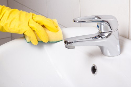 Homeowner maintaining a clean patio with essential tools.